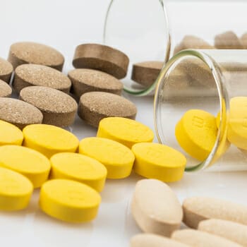Supplements spilled on a glass container