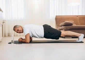 man in a plank position on a yoga mat