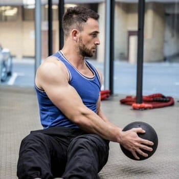 man in a russian twist position