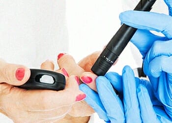A doctor checking someone's blood sugar