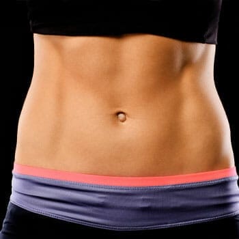 close up image of a woman's toned abs