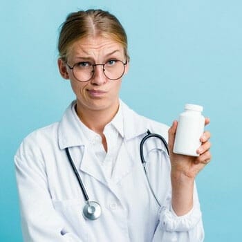 medical person holding up a pill bottle while thinking