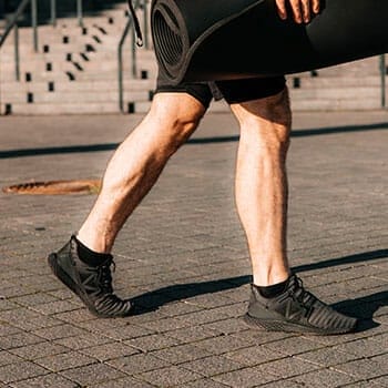 a walking man's calves with muscles