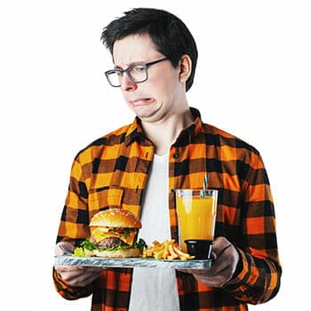 man holding a tray of junk food with a grossed out face