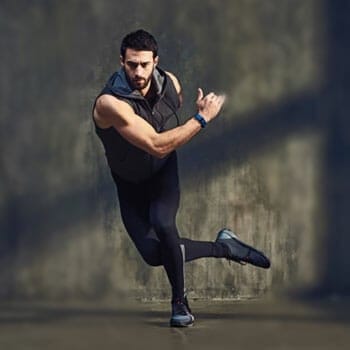 man doing skater exercise in gym clothes