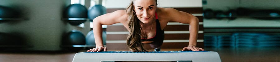 woman smiling while doing push ups