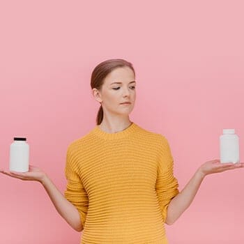 woman holding up two different bottles