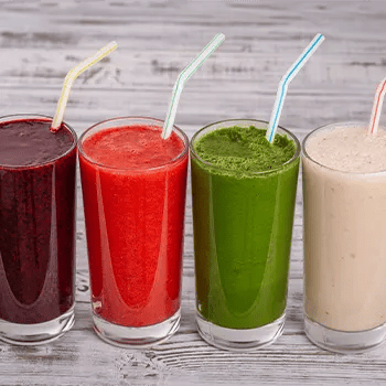 four glasses of different smoothies