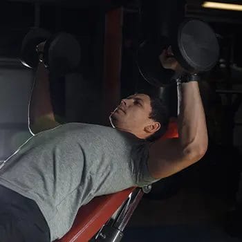 man in an incline dumbbells press position