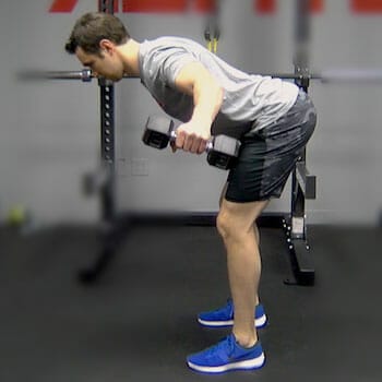 man using dumbbells in a gym
