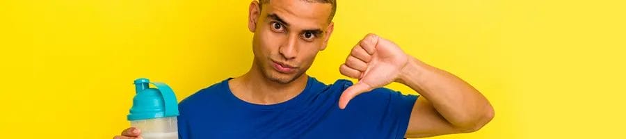 man holding up a tumbler and a thumbs up