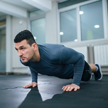 man doing pushups in a gym