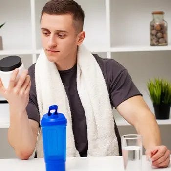 man reading a protein powder label