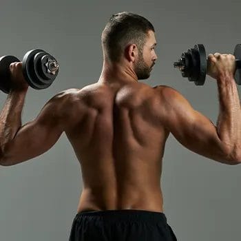 shirtless man using dumbbells while showing off his back muscles