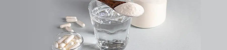 glass of water, spoonful of powder, and some pills