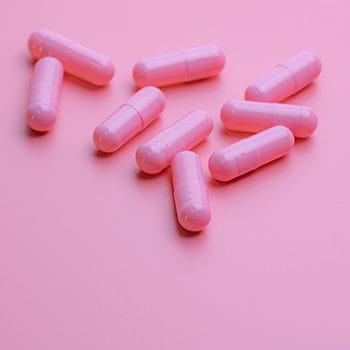 pink capsules on a pink background