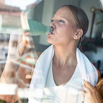 woman chugging a tumbler