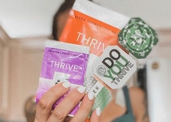 woman holding different thrive products