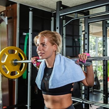 female in the gym lifting a heavy barbell