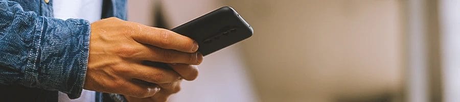 hand view of a person using his phone
