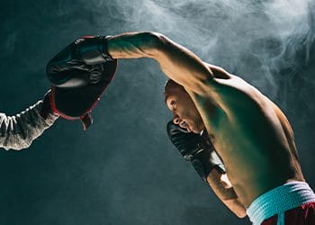 shirtless man boxing