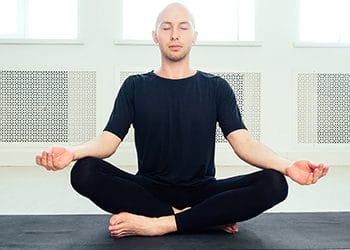bald man in a yoga position
