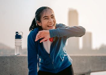 woman wiping her sweat smiling