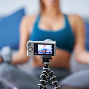 person using a digital cam to record herself working out
