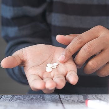 pills on a man's hands