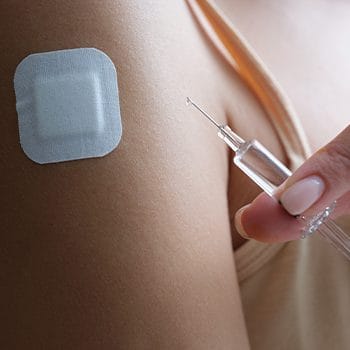close up image of a person using injections and skin patch