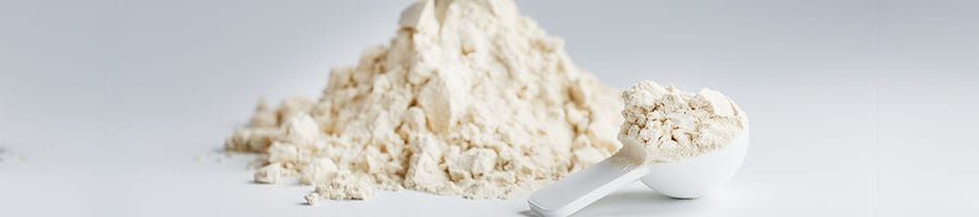 stack of protein powder with a scoper