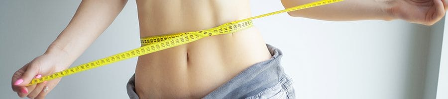 woman measuring her waist