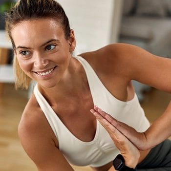 Healthy woman doing exercises indoors