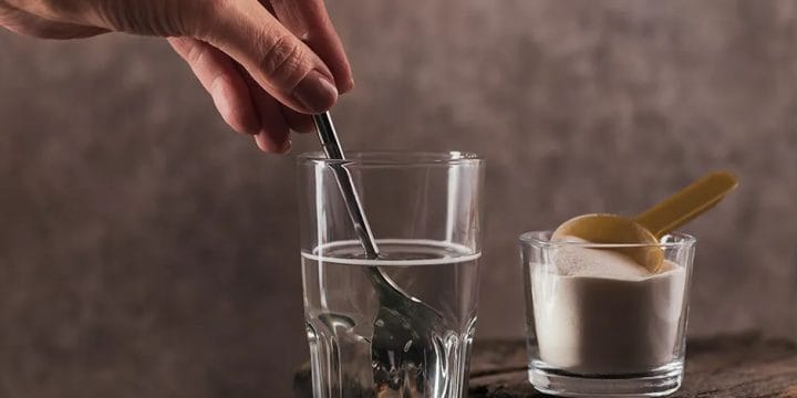 Stirring a glass of water with a protein powder