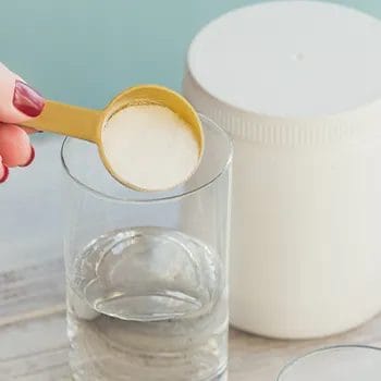 Pouring powder on a glass of water