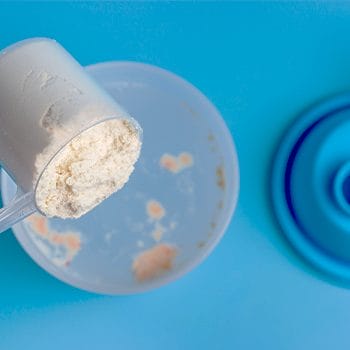 close up image of scooping powder from a container