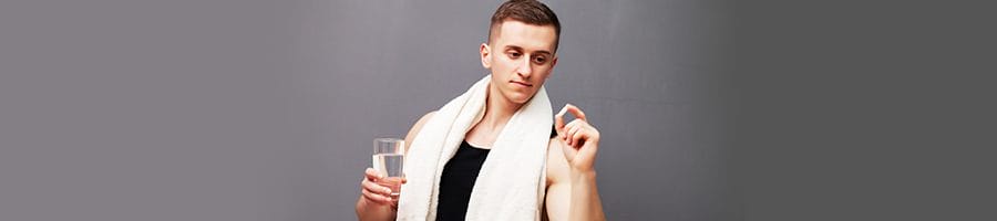 man looking and holding a pill