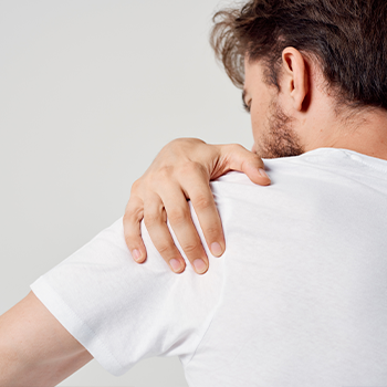 man holding his shoulder in pain