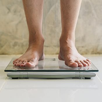feet view of a person using a weighing scale