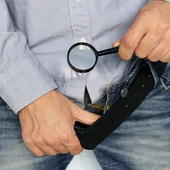 man looking at his brief with magnifying glass