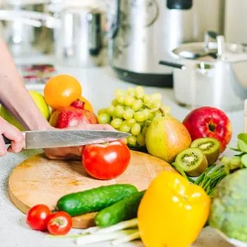 hand view of a person slicing healthy food