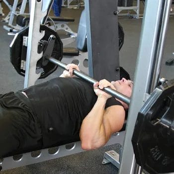 man in a close grip bench press position