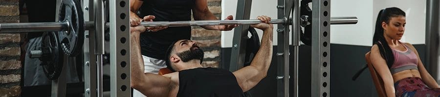man working out with a spotter