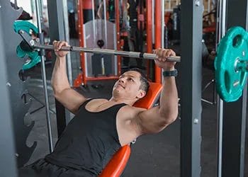 man doing bench presses