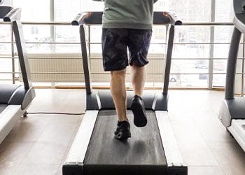 feet view of a man using a treadmill