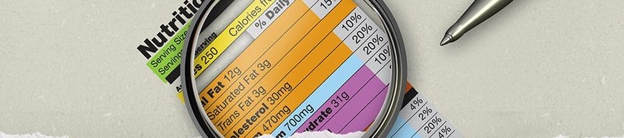 Using a magnifying glass on a nutrition facts