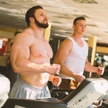 Two men jogging in the gym