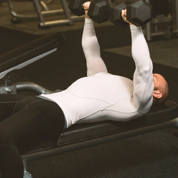 A muscular man doing bench presses