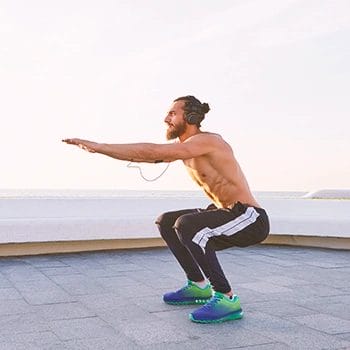 A man doing squats outside