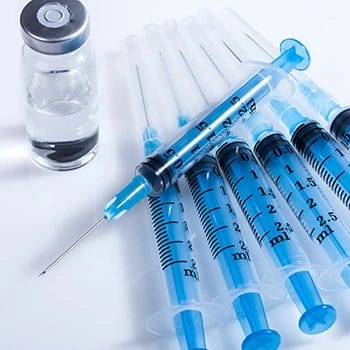 A row of syringes on a table